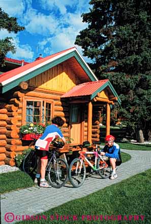 Stock Photo #5853: keywords -  balance bicycle bicycling bike cabin country couple human log mountain peddle power recreation released resort ride roll sport steer summer together transportation two vacation vert wheel wheels