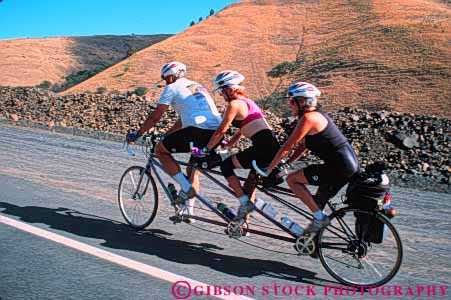 Stock Photo #5856: keywords -  balance bicycle bicycling bike helmet helmets horz human peddle people power recreation ride roll seater sport steer summer tandem three together transportation two unusual vacation wheel wheels