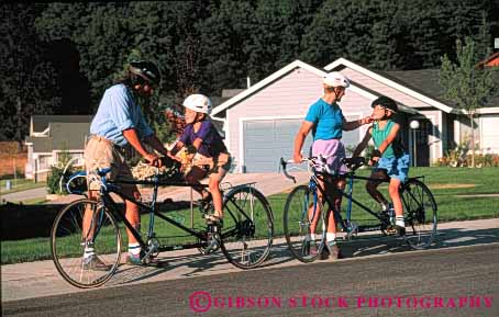 Stock Photo #5857: keywords -  adjust assist assistance balance bicycle bicycling bike boy boys child children family father help horz human husband mother neighborhood peddle power recreation released residential ride roll son sport steer street summer tandem together transportation two vacation wheel wheels wife