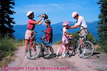 Stock Photo #5858: keywords -  assist assistance balance bicycle bicycling bike boy child children daughter family father girl helmet helmets help horz human husband mother outdoor outdoors peddle power recreation released ride roll son sport steer summer together transportation two vacation wheel wheels wife