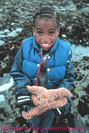 Stock Photo #5878: keywords -  african american animal beach black california child children coast coastal ethnic explore expression face faces facial girl habitat hold holding holds intertidal invertebrate kid kids marine minority moss ocean old sea seashore seven star starfish student surf tidepool tidepooling tidepools vert wave with year youth zone