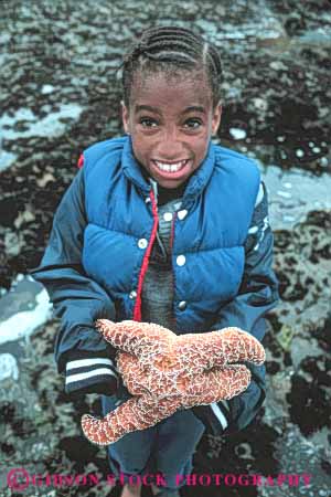 Stock Photo #5878: keywords -  african american animal beach black california child children coast coastal ethnic explore expression face faces facial girl habitat hold holding holds intertidal invertebrate kid kids marine minority moss ocean old sea seashore seven star starfish student surf tidepool tidepooling tidepools vert wave with year youth zone