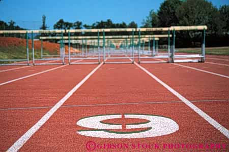 Stock Photo #5927: keywords -  adult and athlete athletic athletics compete competing competition competitor contest event field horz hurdles lane number numbers numerical outdoor outdoors outside path race route school sport sports summer team track