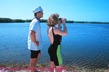 Stock Photo #5975: keywords -  binoculars bird birding birds count counting couple darling fl florida horz husband identify identifying look man nature outdoor outdoors outside refuge see share spot spotting spouse summer team together tracking vision watching wife wildlife