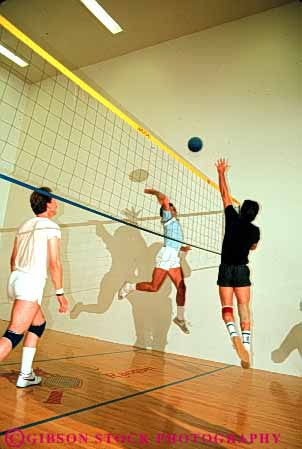 Stock Photo #6209: keywords -  action ball bounce coordinate coordinating coordination court fitness hit indoor jump male man men motion move movement moving net play player players recreation run sport sports team teamwork vert volleyball walleyball woman