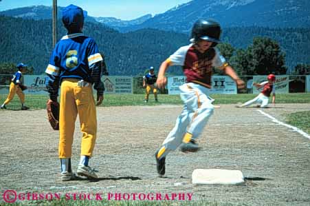 Stock Photo #6220: keywords -  action adolescence adolescent adolescents ball base baseball boy boys catch catcher catching child children cooperate cooperating coordinate coordination diamond field horz motion pitch pitcher pitching play player playing practice recreation rounds run runner running runs score sport sports summer team third throw thrower throwing uniform youth