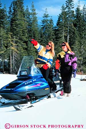 Stock Photo #3536: keywords -  activity adventure clothing equipment explore helmet machine machines outdoor pair people person recreation released season snow snowmobile snowmobiler snowmobilers snowmobiles snowmobiling sport sports transportation two vert winter women