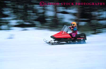 Stock Photo #6257: keywords - activity caution child children cold drive driver driving equipment equipped female fiberglass gear girl helmet helmets horz loud lyoung machines material mobile mobiler mobilers mobiling motor motorized noise outdoor outdoors outfit outside pair people person plastic recreation recreational ride risk season snow snowmobile snowmobiler snowmobilers snowmobiles snowmobiling sport sports steer suit synthetic transport transportation two vehicle winter youth