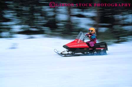 Stock Photo #6257: keywords -  activity caution child children cold drive driver driving equipment equipped female fiberglass gear girl helmet helmets horz loud lyoung machines material mobile mobiler mobilers mobiling motor motorized noise outdoor outdoors outfit outside pair people person plastic recreation recreational ride risk season snow snowmobile snowmobiler snowmobilers snowmobiles snowmobiling sport sports steer suit synthetic transport transportation two vehicle winter youth