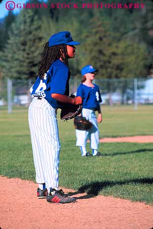 Stock Photo #12311: keywords - african american attention attentive baseball black california child children concentrate concentrates concentrating ethnic game games girl league little minority mt outdoor outside recreation season shasta softball sport sports summer team uniform uniforms vert