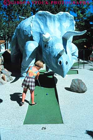Stock Photo #6293: keywords - adolescence adolescent adolescents artificial ball challenge challenging child children club contest course dinosaur fake family fun game girl girls golf golfer golfers golfing imitation miniature outdoor outdoors outside play player players playing putt putter putters putting recreation released roll rolling score skill sport sports summer tricerotops vacation vert youth