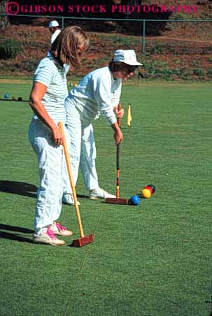 Stock Photo #6309: keywords -  aim ball contest court croquet field game grass green hit hoop lawn mallet outdoor outdoors outside pair play practice precise precision recreation roll skill sport summer tap team two uniform vert white woman