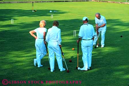 Stock Photo #6312: keywords -  adult aim ball contest couple couples court croquet elderly field game grass green group hit hoop horz lawn mallet mature old outdoor outdoors outside pair play practice precise precision recreation roll senior seniors skill sport summer tap team uniform white