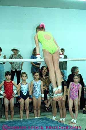 Stock Photo #6339: keywords - adolescence adolescent adolescents bars child children compete competing competition competitor contest coordination female girl girls gymnast gymnastics indoor perform performance performer performing practice recreation skill sport strength uneven vert