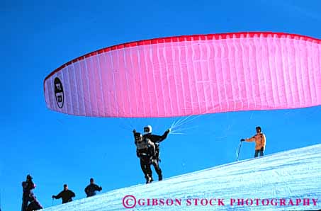 Stock Photo #6363: keywords - air colorful crash danger dangerous dive drift flight float fly flyer flying glide gravity horz idaho injure injury lift off parachute paraglide paraglider paragliders paragliding pink recreation resistance risk risky sky sport steer sun suspend suspended valley winter
