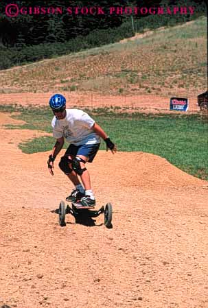 Stock Photo #6364: keywords -  balance board boarding course curve dirt downhill glide gravity helmet man mountain mountainboarding outdoor outdoors outside roll stand steer turn vert wheel wheels