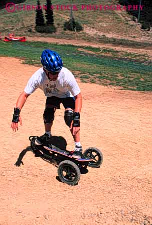 Stock Photo #6365: keywords -  balance board boarding course curve dirt downhill glide gravity helmet man mountain mountainboarding outdoor outdoors outside roll stand steer turn vert wheel wheels