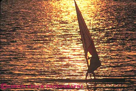 Stock Photo #10821: keywords -  air balance boat boaters boating boats california dusk evening golden horz ocean orange outdoor outside power practice recreation reflect reflecting reflection reflects ripple ripples river sacramento sail sailboard sailboarder sailboarding sailboards sailing sails silhouette silhouettes skill sport sports strength sunset sunsets water wind windsurf windsurfer windsurfers windsurfing