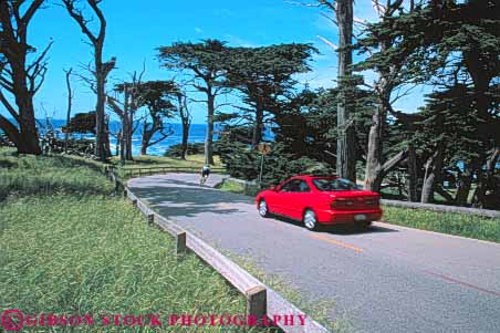 Stock Photo #10858: keywords -  (near ) and bicycle bicyclist bike biker california car carmel cars coast coastal drive horz landscape landscapes mile monterey near red resort resorts road roads scenery scenic seashore seventeen shore shoreline street streets summer water