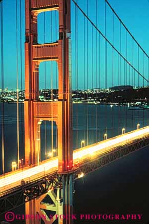 Stock Photo #10509: keywords -  bay blur blurred bridge bridges bright cable california dark dusk engineer engineered engineering evening famous francisco gate golden headlight headlights landmark landmarks lights metal night red san span spans steel streak streaks suspension tall tower towers traffic vert water