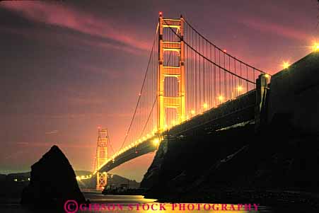 Stock Photo #10511: keywords -  bay bridge bridges cable california dark dusk engineer engineered engineering evening famous francisco gate golden horz landmark landmarks lighting metal red san span spans steel sunset sunsets suspension tall tower towers water