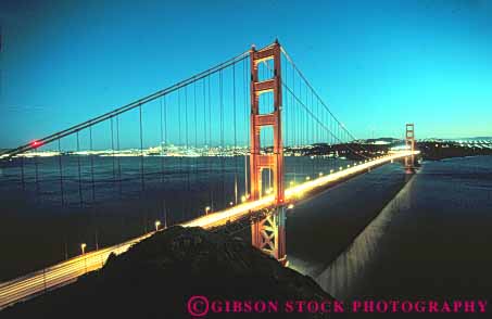 Stock Photo #10513: keywords - bay bridge bridges cable california dark dusk engineer engineered engineering evening famous francisco gate golden headlights horz landmark landmarks light lighting metal night red san span spans steel streaks suspension tall tower towers traffic water