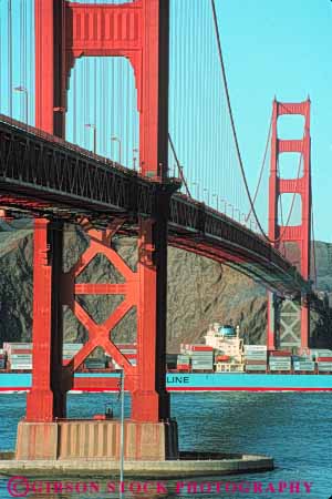 Stock Photo #10520: keywords -  bay bridge bridges cable california commerce container engineer engineered engineering famous francisco freight freighter gate golden industry landmark landmarks metal passing red san ship shipping span spans steel suspension tall tower towers transport transportation transporting under vert water