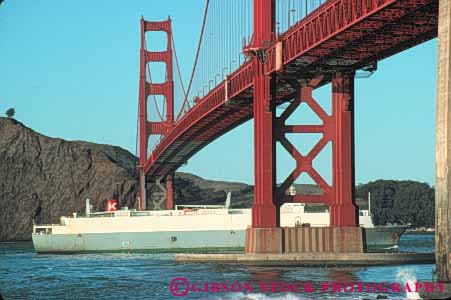 Stock Photo #10521: keywords - bay bridge bridges cable california car commerce engineer engineered engineering famous francisco freight freighter gate golden horz industry landmark landmarks metal new passing red san ship shipping span spans steel suspension tall tower towers transport transportation transporting under water