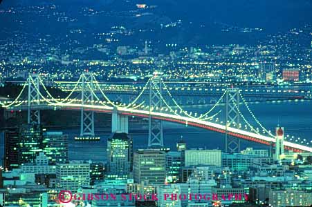 Stock Photo #10577: keywords - bay bridge bridges california cities city cityscape cityscapes connect connected connects dark dusk engineer engineered engineering evening francisco highway highways horz landmark landmarks lighting lights metal night pattern road roads san scallop span spans steel streak streaks street streets support supports suspend suspended suspension tall tower towers traffic urban