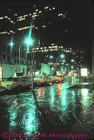 Stock Photo #10669: keywords -  buildings cab cabs california car cars center cities city dark downtown francisco glare glares lamp lamps lighting lights night parked rain rainy reflect reflection reflects san sidewalk street streets taxi urban vert wet