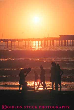 Stock Photo #9438: keywords - beach beaches california cement coast coastal concrete diego dock docks dusk near ocean orange people pier piers pile piling pilings platform san sea seashore shore shoreline silhouette silhouettes summer sun sunset sunsets vert warm water
