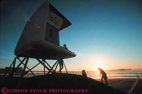 Stock Photo #9441: keywords - beach beaches california coast coastal diego dock docks dusk horz lifeguard ocean piers san sea seashore shore shoreline silhouette silhouettes stand summer sunset sunsets warm