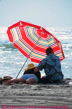 Stock Photo #9466: keywords -  affection beach beaches california cities city colorful couple diego husband love loving man san shade share spouse summer tender together touch umbrella umbrellas under vacation vert wife woman