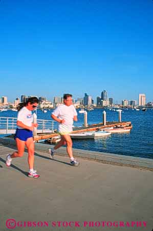 Stock Photo #9468: keywords -  action along blur blurred california cities city couple diego exercise exercising fitness friend friends health healthy jog jogger joggers jogging man motion movement moving outdoor outside recreation run runner runners running runs san sidewalk sport sports summer team vert waterfront woman workout