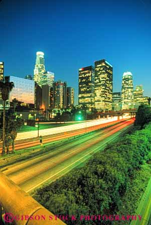 Stock Photo #7812: keywords -  america american angeles architecture blur blurred building buildings business california center cities city cityscape cityscapes dark downtown dusk dynamic evening freeway high highway interstate lighting lights los modern move movement moving new office reflection rise skyline skylines streak streaks traffic urban usa vert