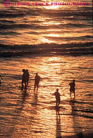 Stock Photo #9826: keywords -  beach beaches california children coast coastal dusk evening group in monica ocean play playing sand sandy santa sea seashore shore shoreline silhouette silhouettes sunset sunsets surf swim swimming together vert warm water