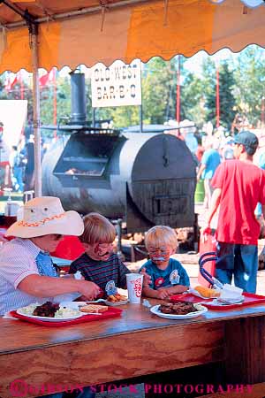 Stock Photo #12127: keywords -  activity alberta annual barbecue calgary canada children eat eating event events fair fairs family festival festivals food gathering people social stampede vert