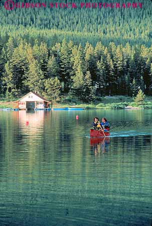 Stock Photo #12093: keywords -  alberta boat boaters boating calm canada canoe canoeing canoes destination families family jasper lake lakes maligne mountains national paddle paddles paddling park parks peaceful public quiet recreation relax relaxing released rocky travel vert water