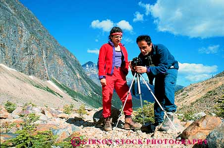 Stock Photo #12499: keywords -  alberta camera cameras canada couple hike hiker hikers hiking horz jasper landscape man national outdoor outside park people photo photograph photographic photographing photography released scenery scenic tripod woman