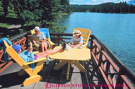 Stock Photo #12501: keywords - adult adults alberta beauvert book books calm canada deck decks furniture horz jasper lake lodge national outdoor outside paint painted park parks patio patios people public quiet read reader readers reading relax relaxed relaxes relaxing rest tourist tourists traveler travlers wood yellow
