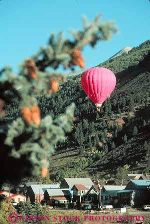 Stock Photo #12845: keywords -  air attraction attractions balloon balloons bright colorado drift drifting drifts float floating floats historic hot mountain mountains recreation red rocky round scenery scenic sphere telluride tourist town towns vert west western