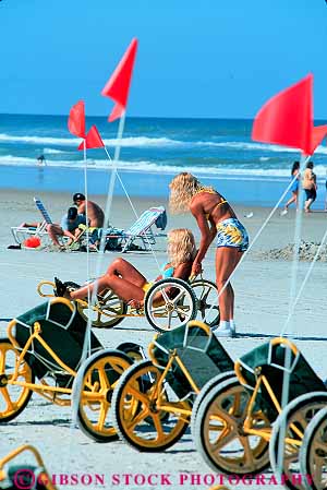 Stock Photo #12875: keywords -  beach beaches bicycles bike bikes coast coastal daytona destination florida leisure ocean peddle peddles peddling play recreation rental rentals resort resorts ride rider riders riding shore shoreline south summer sunny sunshine three travel tricycle tricycles try vacation vert woman women