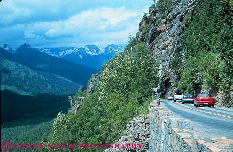 Stock Photo #12902: keywords -  auto automobiles autos car cars cliff enter glacier going highway highways horz landscape landscapes montana mountain mountains national nature park parks public road rocky scenery scenic steep street sun traffic tunnel tunnels wilderness