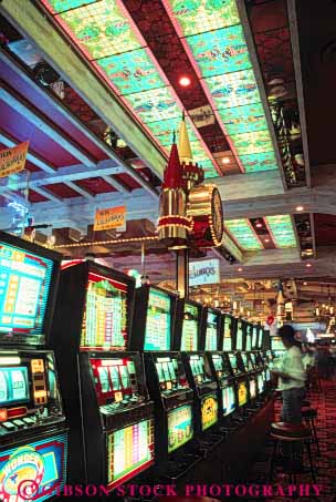 Stock Photo #8266: keywords -  area attraction casino casinos color colorful decor decorate decoration design destination excalibur gamble gambling gaming inside interior las lighting lights machine machines neon nevada row rows slot tourist travel usa vacation vegas vert