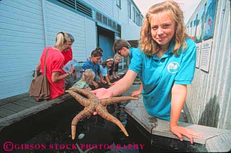 Stock Photo #10328: keywords -  animal animals aquarium aquariums child children girl girls hands hold holds horz interactive kid life marine museum museums northwest outdoor outside public science sea seattle staff star starfish touch touching washington