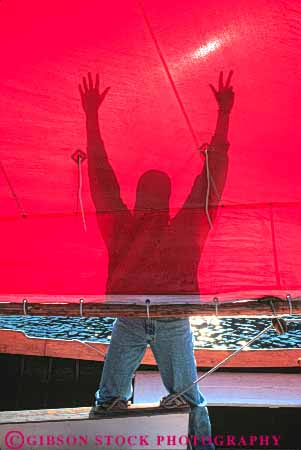 Stock Photo #10339: keywords -  bizarre boat boating boats center club clubs dock docks heritage man marina marinas marine maritime northwest red sail seattle shadow shadows silhouette silhouettes strange unusual vert washington wood wooden