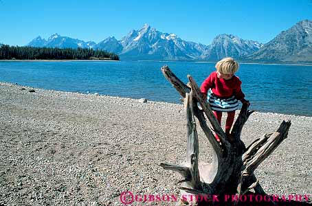 Stock Photo #12997: keywords - alpine child climb climber climbing climbs environment girl grand habitat horz jackson lake lakes landscape mountain mountains natural nature outdoor outside parks play playing plays public recreation released rocky scenery scenic shore stump summer teton tetons tree west western wyoming