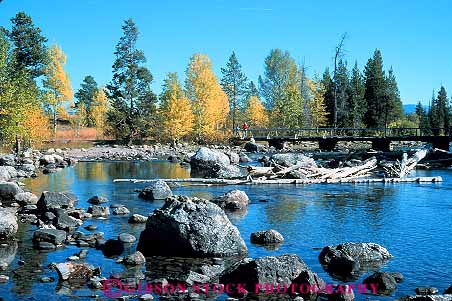 Stock Photo #13001: keywords -  alpine autumn bridge bridges color deciduous environment fall foliage foot grand habitat hike hikers hikes hiking horz jenny lake lakes landscape mountain mountains national natural nature outdoor outside park parks people public recreation rocky scenery scenic season teton tetons west western wyoming
