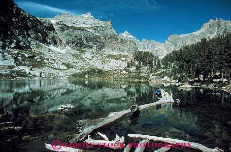 Stock Photo #13005: keywords -  alpine amphitheater environment grand habitat hike hiker hikes horz lake lakes landscape log man men mountain mountains national natural nature outdoor outside park parks public rocky scenery scenic sit sits sitting summer teton tetons west western wyoming