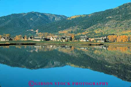 Stock Photo #13020: keywords -  alpine apartment autumn building calm color condo condos destination fall flat foliage hole horz image jackson lake lakes landscape mirror mirroring mountain mountains outdoor outside pond ponds reflect reflecting reflection reflects resort resorts rocky scenic summer teton tetons tourist town towns travel village water west western wyoming